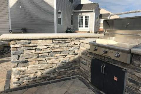 Stone veneer wall detail for outdoor living feature