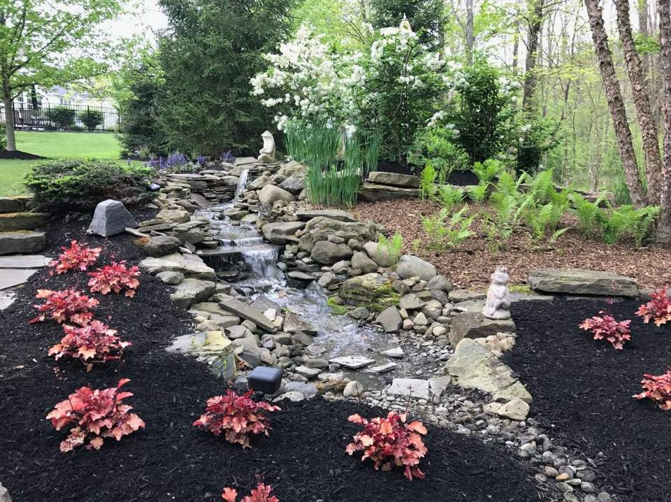 Pond edge water feature with natural stone